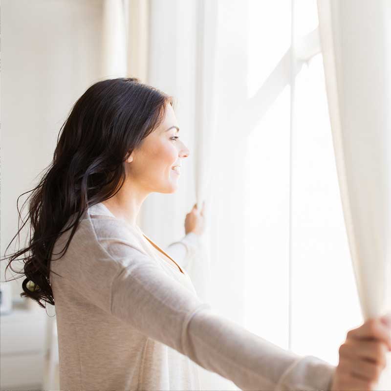 woman looking out window